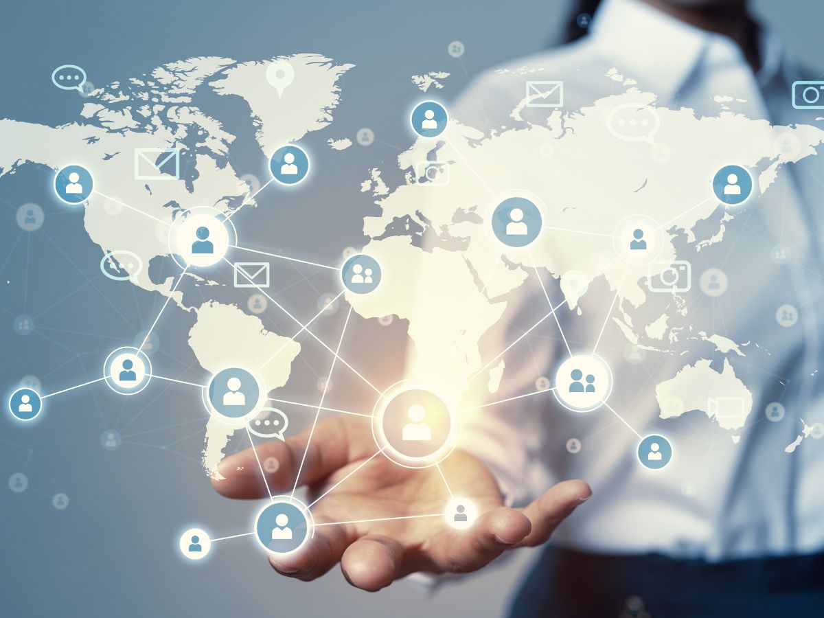 women holding a representation of maps connecting global banks